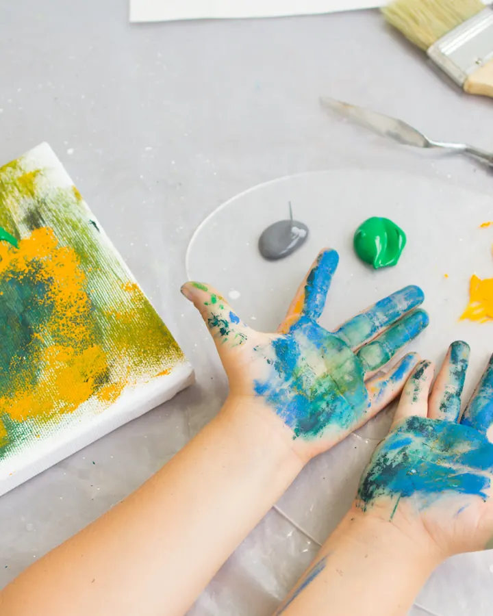 Small hands painting at the studio table