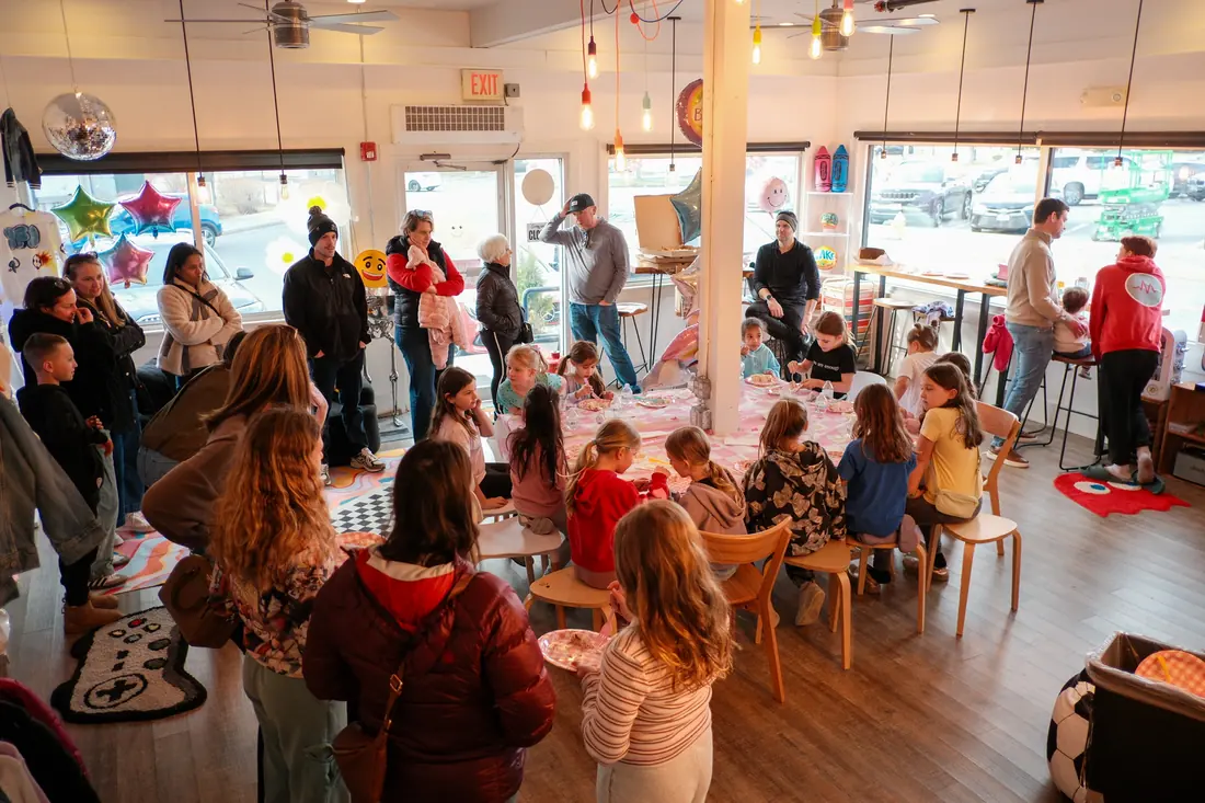 The party room from above, guests painting around the long table