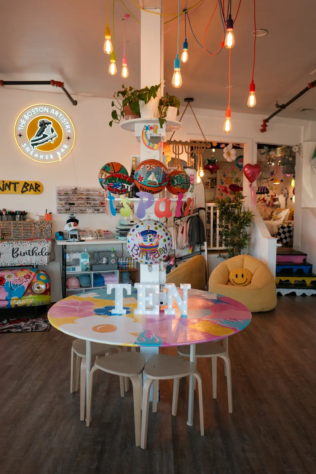 The studio set for a tenth birthday, balloons and blank projects on the table